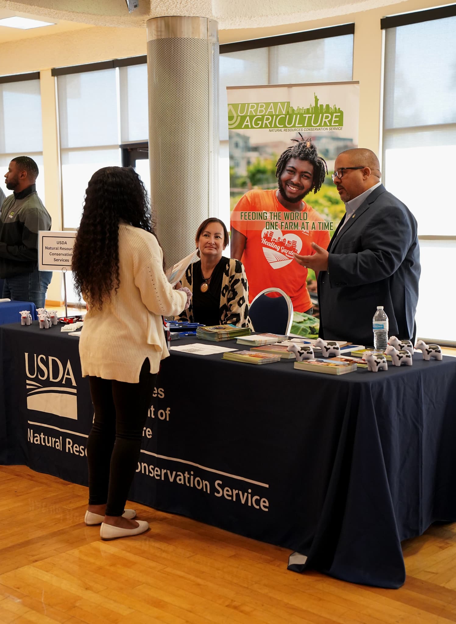 A student engages with the USDA booth at the LU Career Fair, exploring potential careers in agriculture and environmental services.