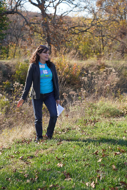 Missouri Prairie Foundation Executive Director Carol Davit speaks during the pre-conference tour of native plantings in Jefferson City, Missouri, highlighting the native plant initiative at McClung Park and sharing examples from her own home to inspire attendees to incorporate native plants into their own spaces.