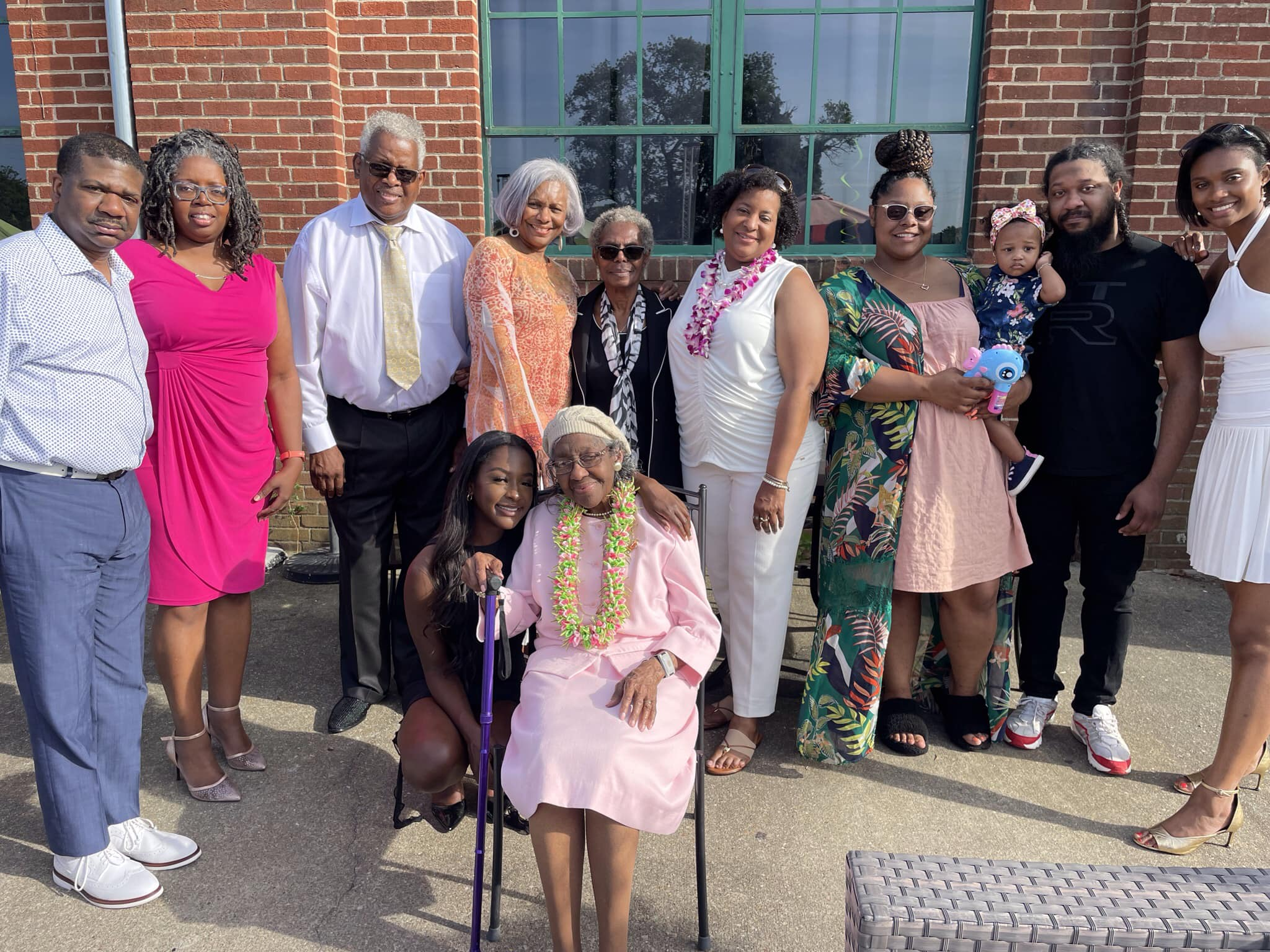 Mrs. Ouida Tolbert, Lincoln University of Missouri retired professor, sits in a chair in the center of the photo surrounded by her family members.