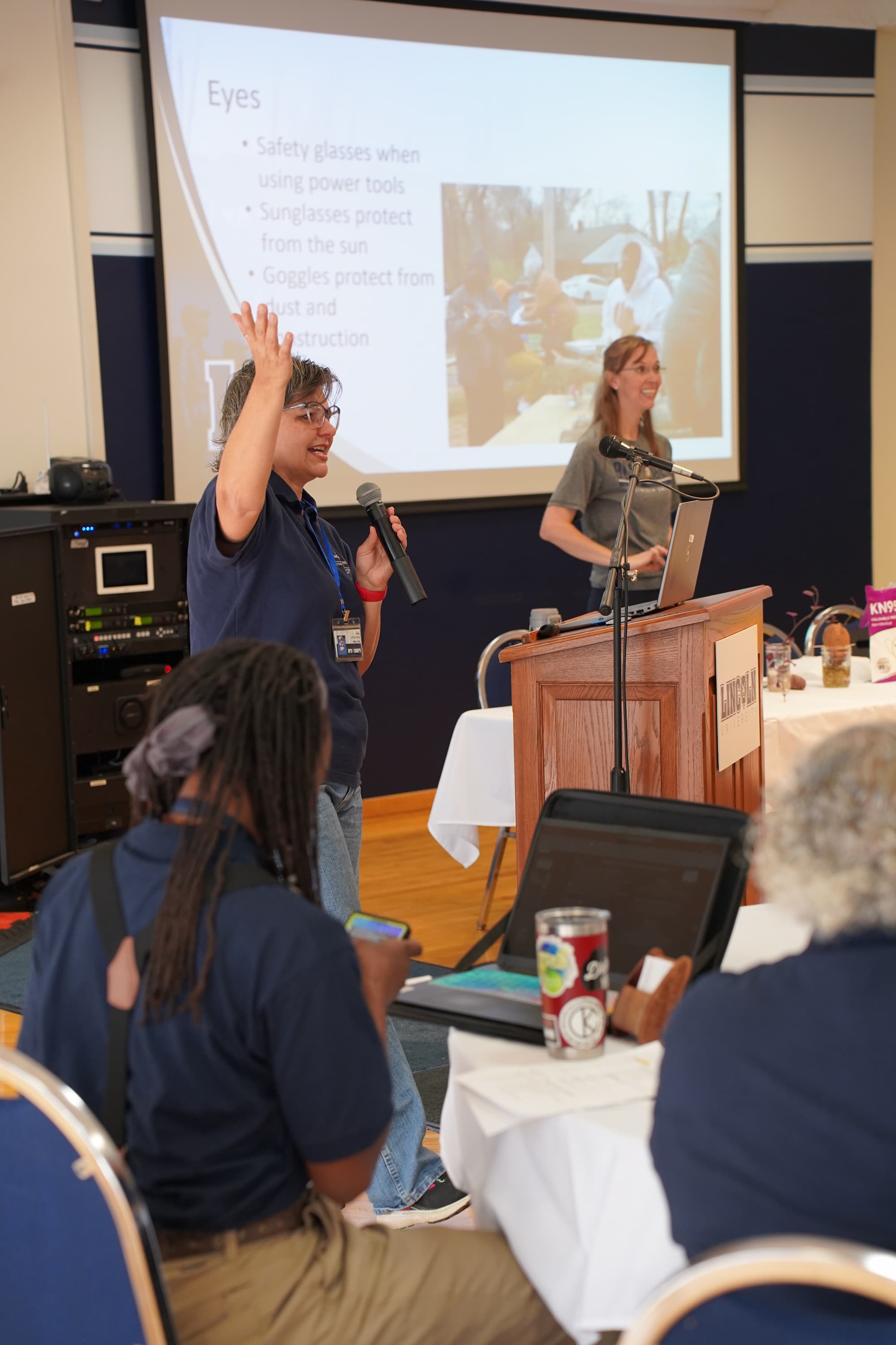 LUCE’s farm outreach workers Penny Wilson (left) and Mary Keeter (right) discuss essential protective gear for gardening and handling chemicals.