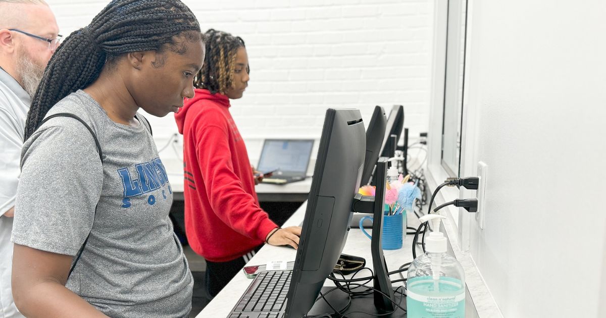 Lincoln University students look at computers during fall 2024 move-in day.