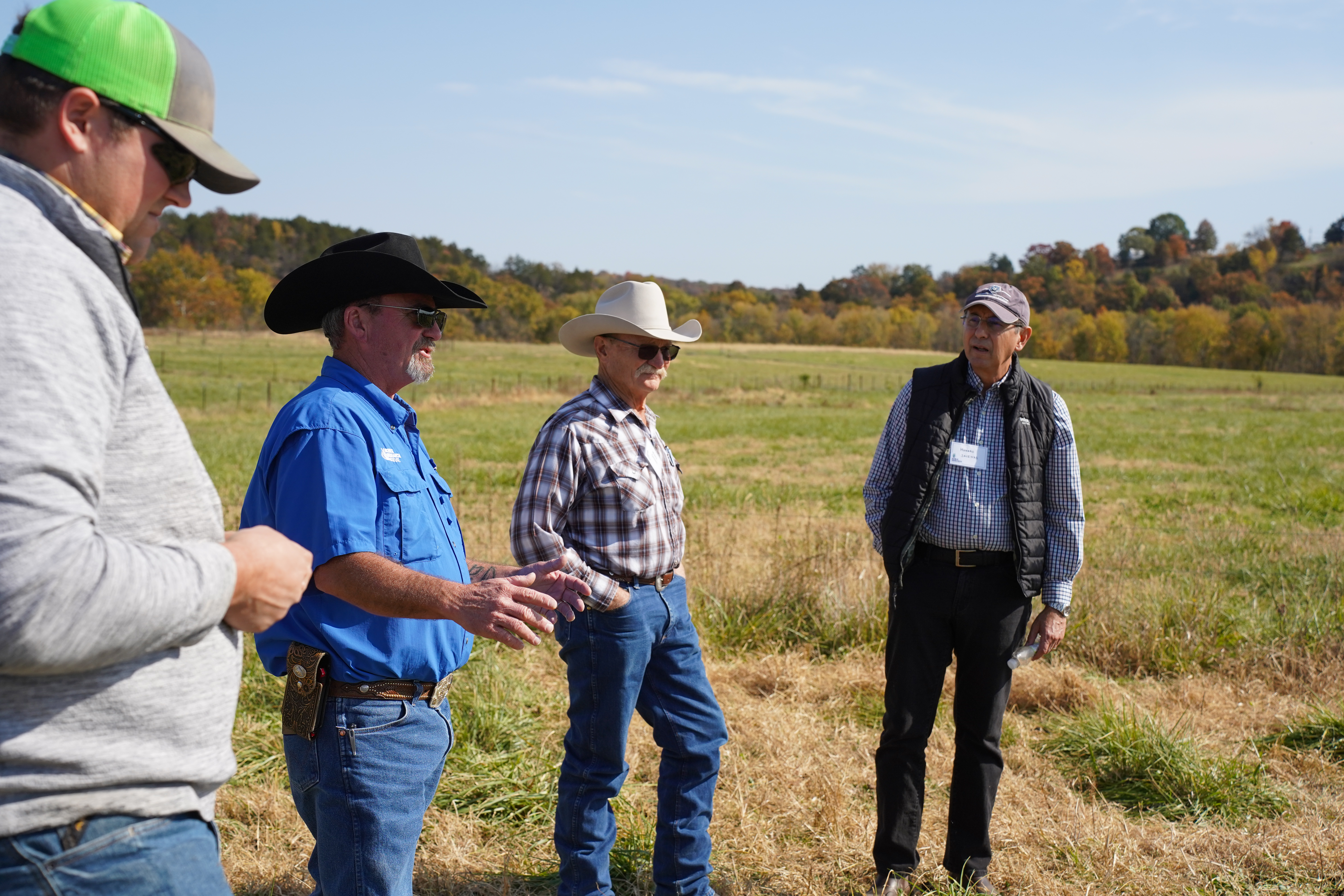 Devlon Ford (second from the left), regenerative ranching consultant, shares expertise on sustainable grazing techniques, emphasizing practical strategies for soil health and pasture resilience.