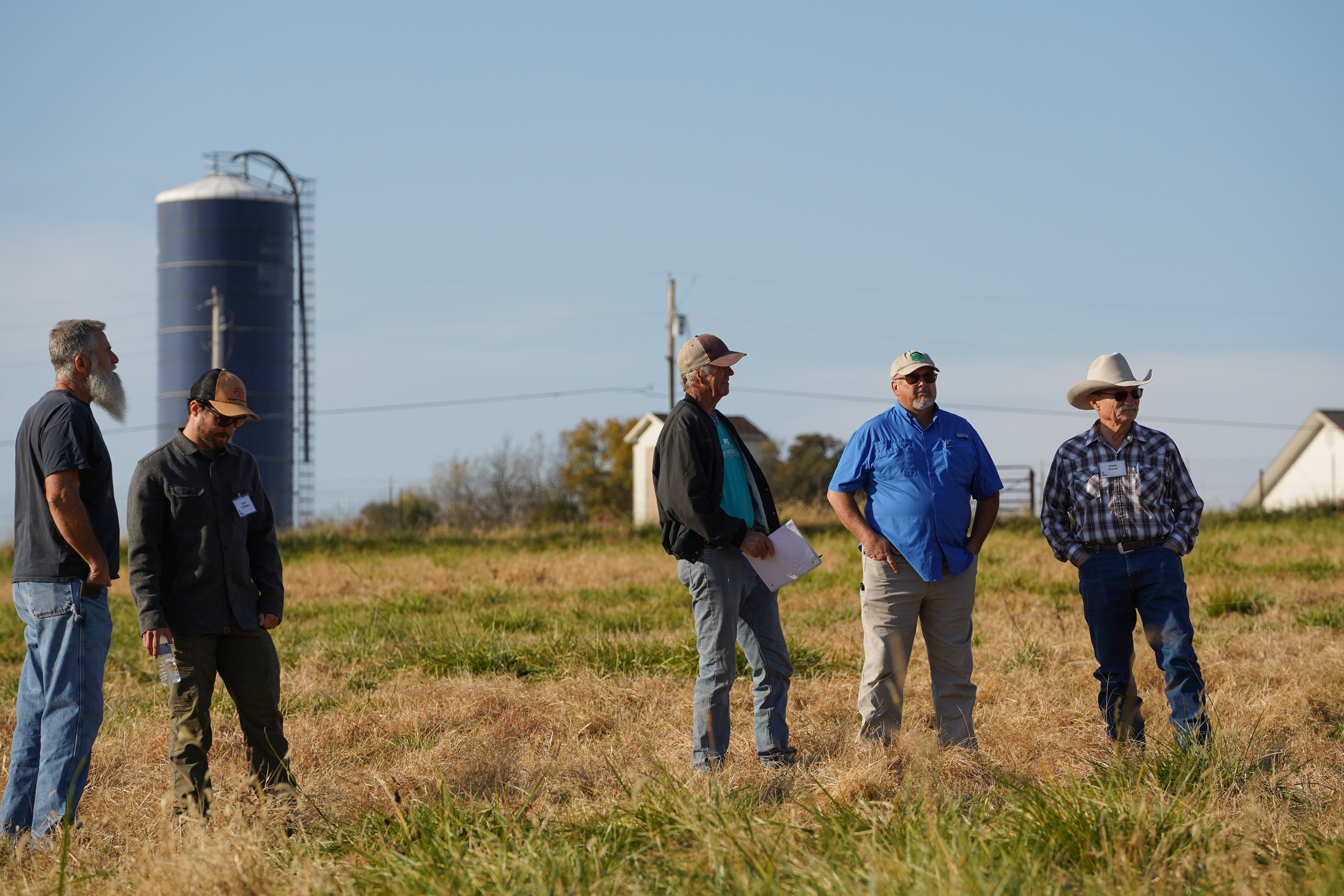 At Carver Farm, participants pause between sessions to network and discuss practical approaches to regenerative grazing, fostering collaboration and shared learning.