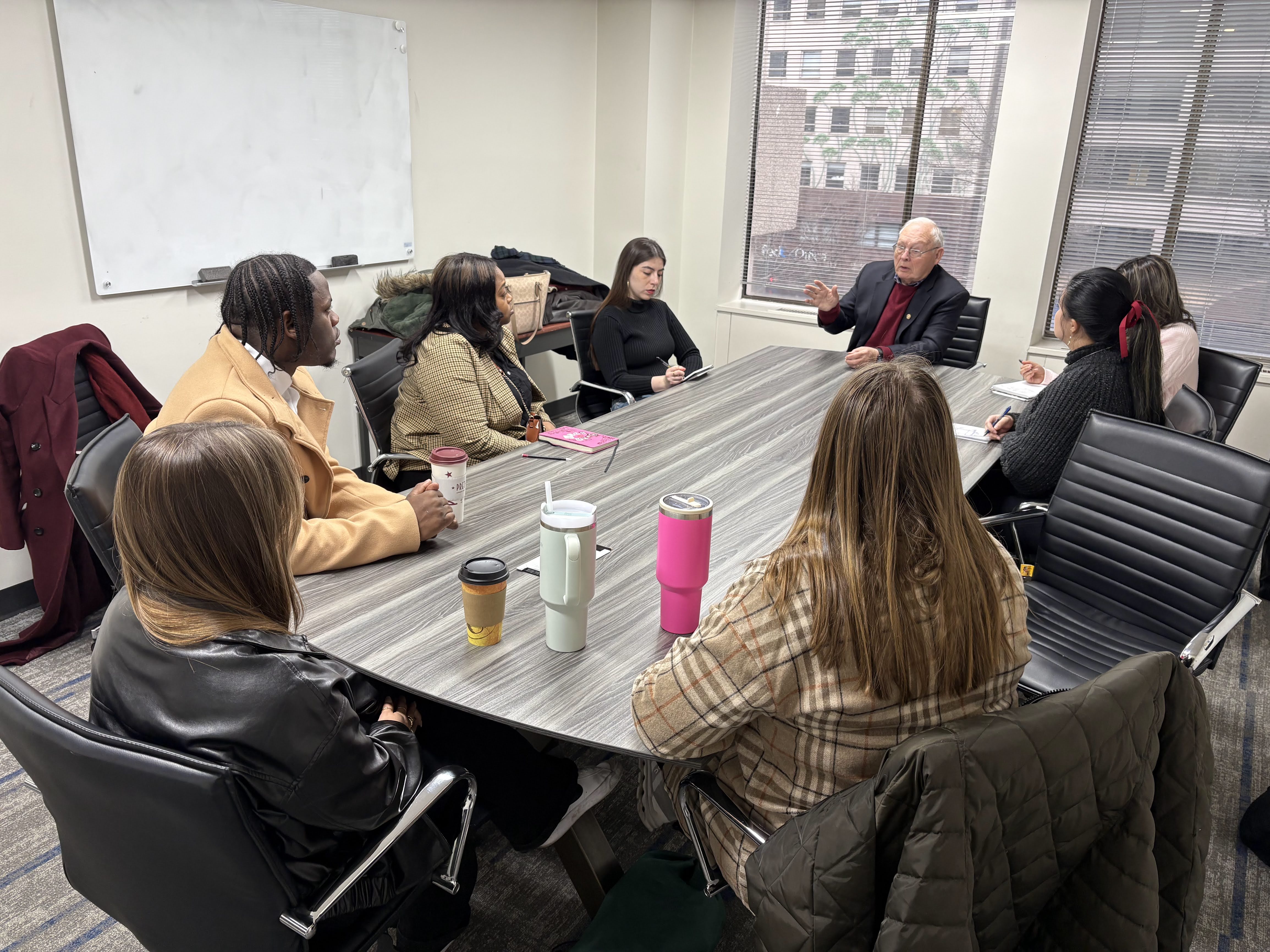 Dr. Shelly Williams, president of the Osgood Center for International Education in Washington, D.C. (head of the table), discussed his career with Lincoln University of Missouri and University of California students. His experience includes developing regulatory frameworks for nuclear technology worldwide and serving as a college professor.